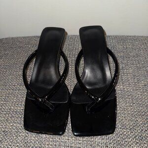 Black latex, open toe kitten heel. Flip flop style